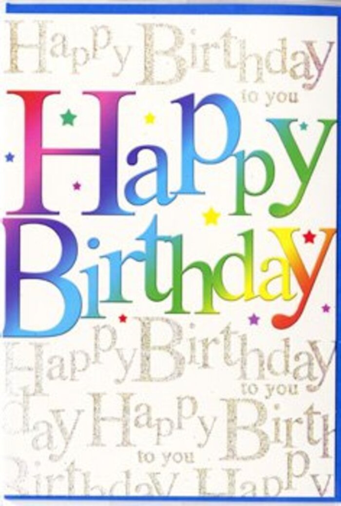 The image shows a delightfully festive 'Happy Birthday' card, photographed so that the viewer is drawn straight into its colourful heart, much like catching sight of a bright party display through a Radlett shop window. Dominating the centre, the phrase Happy Birthday is printed in large, confident, block letters that arch across the card with playful assurance. Each letter is a different saturated colour-raspberry, apricot, golden yellow, meadow green, teal, sapphire, and plum-yet they are blended so fluidly that one shade seems to breathe into the next, creating a smooth rainbow gradient. This harmony of tones is reminiscent of a mixed birthday bouquet, where each flower adds its own hue while still feeling part of a coherent design. Behind the main text, the background is a soft pale cream, over which fine lines of repeating gold script run from edge to edge. The handwritten-style phrase Happy Birthday to you loops and curls in elegant strokes, catching the light with a gentle metallic gleam, almost like morning sunlight sliding over the shopfronts on Watling Street. This shimmering script adds depth and texture without competing with the central words, acting more like a warm, continuous chorus. Tiny, colourful flecks and starbursts hover around the letters, evoking a scatter of confetti just thrown into the air. The card surface appears smoothly coated, with a subtle gloss that enhances both the bright colours and the glittering gold. Overall, the design feels joyful and generous, suitable for any age, and would pair beautifully with a vibrant birthday arrangement delivered to a home near Newberries Park or an evening gathering in one of Radlett's cosy, flower-filled dining rooms.