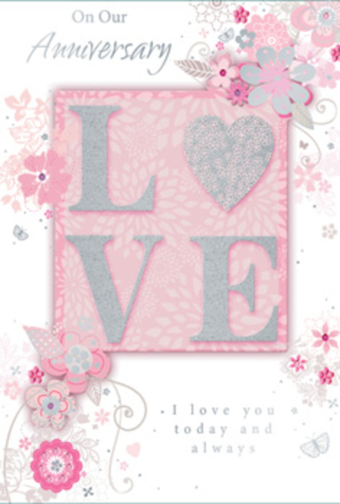 The anniversary card shown here feels like a paper bouquet, its design echoing the romantic arrangements often delivered around Radlett for special milestones. In the centre, the word LOVE stands proudly in raised, glitter-dusted letters, each character gently rounded and smooth under the fingertips. The glitter is soft and frosted rather than bold, creating a shimmering effect that resembles sunlight glancing off petals in a quiet garden off Watling Street. The letters sit on a slightly darker blush pink panel, giving them depth and the sense of being framed, much like a focal bloom in a carefully structured arrangement. Surrounding this centrepiece, a cloud of hand-drawn floral motifs drifts outward: fine, looping vines, petite blossoms with layered petals, and slender leaves that twist and curl as though caught in a light breeze. The colour scheme is a serene blend of blush pink, pale ivory, and hints of lilac-grey, all brushed with occasional touches of silver that highlight edges and centres, creating a gentle sparkle similar to the sheen of a satin ribbon tied around a Radlett anniversary bouquet. The background remains a soft, even pink, providing a warm, romantic setting that lets every flower and swirl remain clearly defined without feeling crowded. An elegant anniversary message in a flowing script sits either above or below the central word, the lettering slightly elongated and refined, as though written by hand in a treasured card kept on a bedside table. The overall feeling is one of intimacy and gratitude: a quiet, dreamlike celebration of shared years, perfect for pairing with fresh flowers delivered locally to homes across Radlett and the surrounding lanes.
